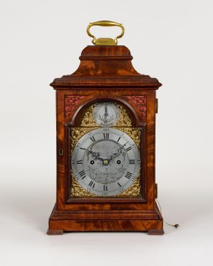 RIVERS & SON. A George III period figured mahogany table clock of rare small size.